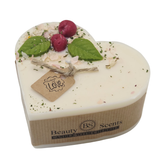 Heart-shaped candle with wax cherries green leaf and 'Beauty Scents' branding on a white background