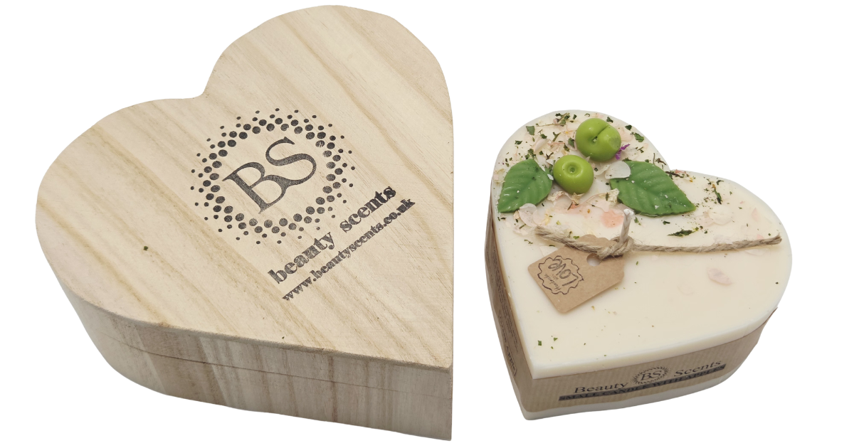 Heart-shaped wooden box with 'Beauty Scents' logo and a heart-shaped apple candle with green leaves and apple wax melts on a white background