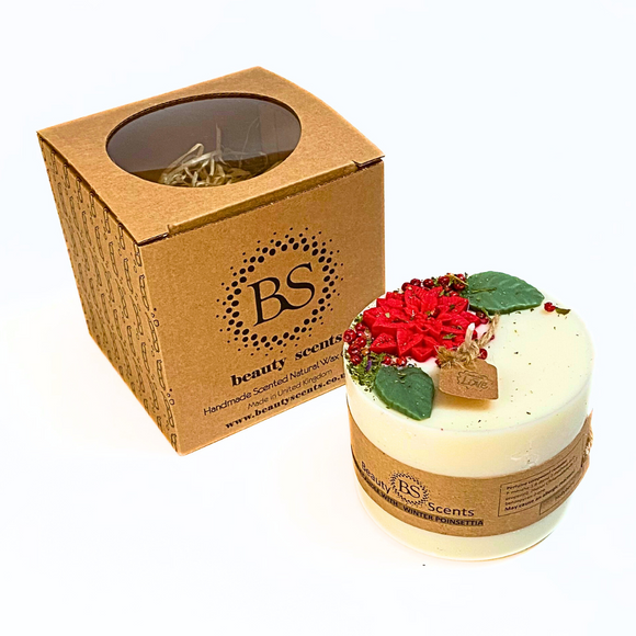 Large Winter Poinsettia pillar candle with Hollyberry scent featuring red poinsettia flowers and green leaves