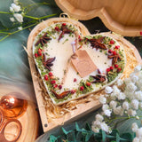 Large heart-shaped mulled wine scented candle with star anise and red berries in elegant wooden heart gift box with Christmas decorations