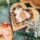 Large heart mulled wine candle in wooden heart-shaped gift box with natural wood shavings and romantic presentation