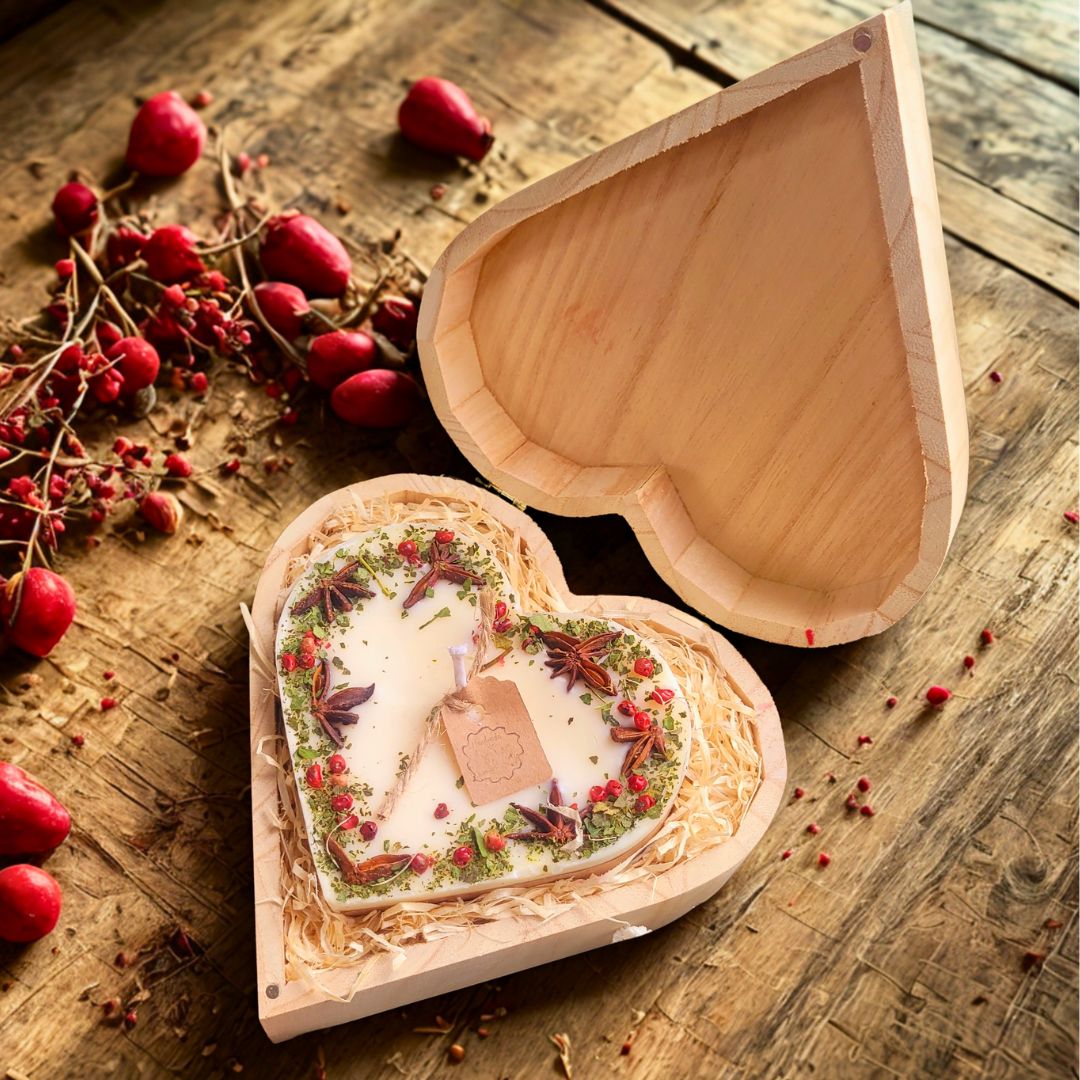 Large heart-shaped mulled wine scented candle with detailed view of star anise and red berry decorations in heart gift box