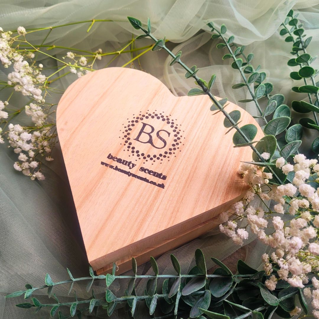 Heart Gift Box Large Heart Orange Cinnamon candle lifestyle shot with white flowers and soft green textile background