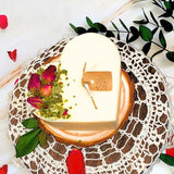 Decorative candle with flowers on a textured surface