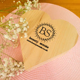 Large heart hollyberry candle in elegant wooden heart gift box with red poinsettia decoration and premium winter styling