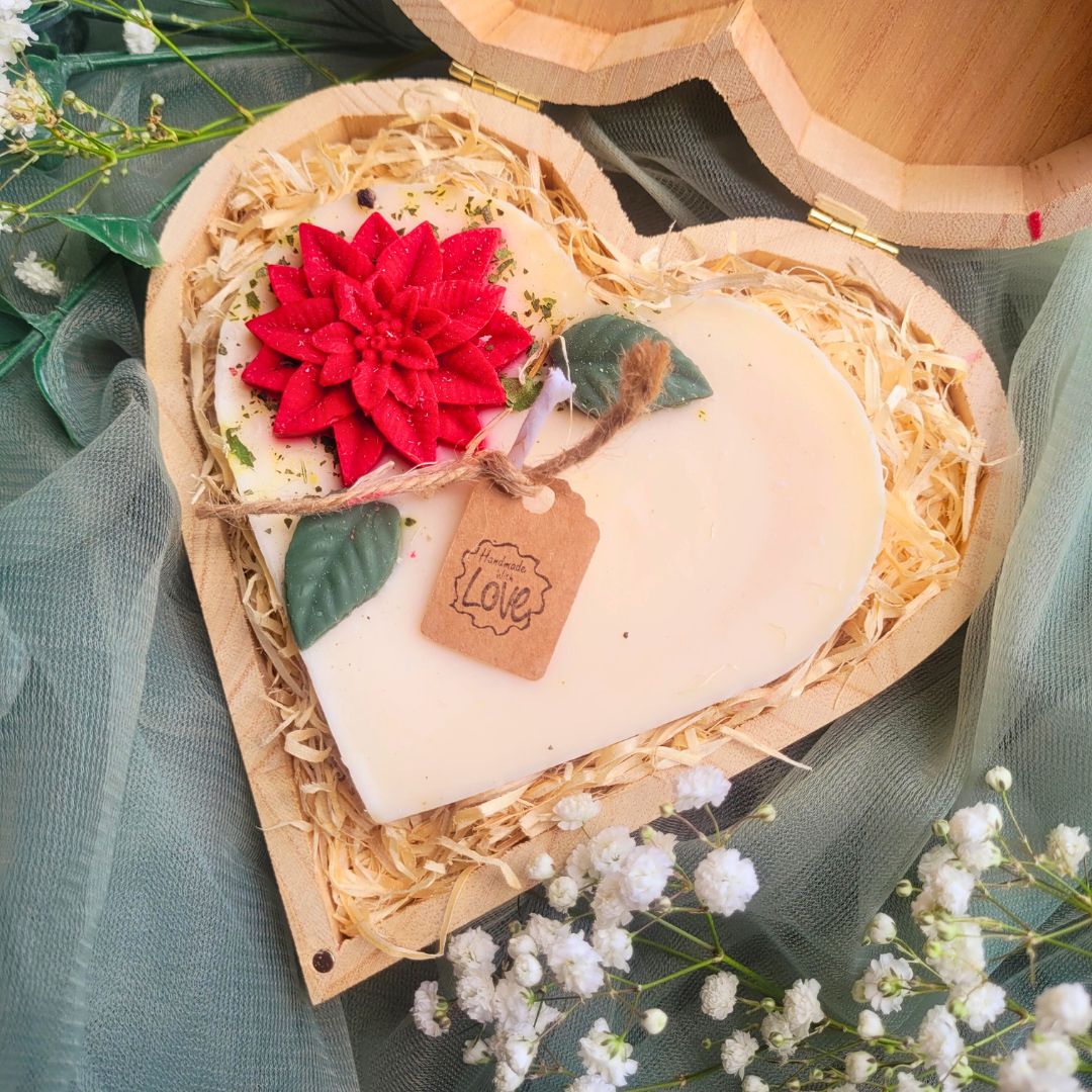 Heart Gift Box Large Heart Hollyberry candle lifestyle shot with white flowers and soft green textile background