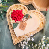 Heart Gift Box Large Heart Hollyberry candle lifestyle shot with white flowers and soft green textile background