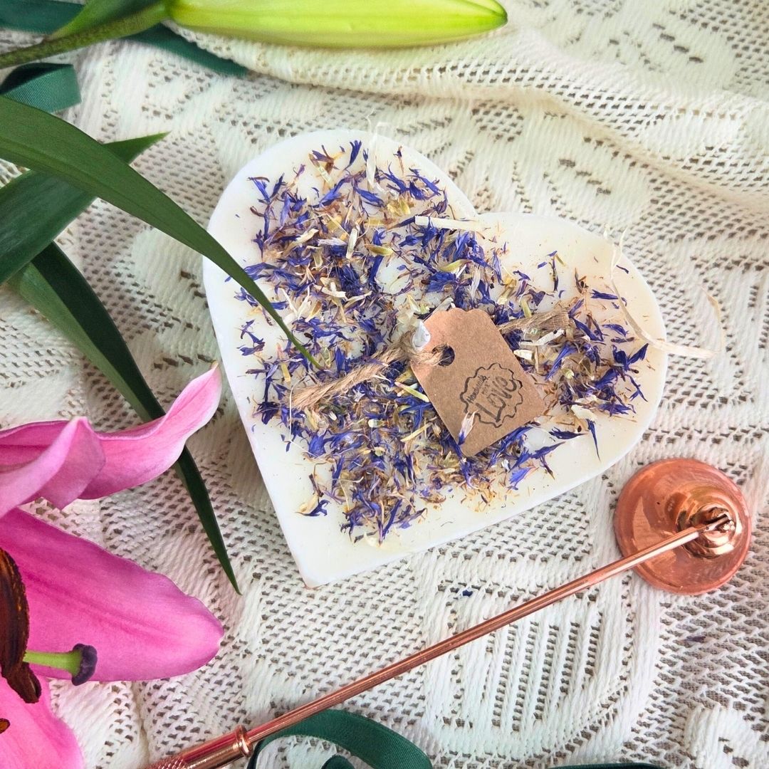 Detailed view of wooden heart box and wild flower candle, perfect gift