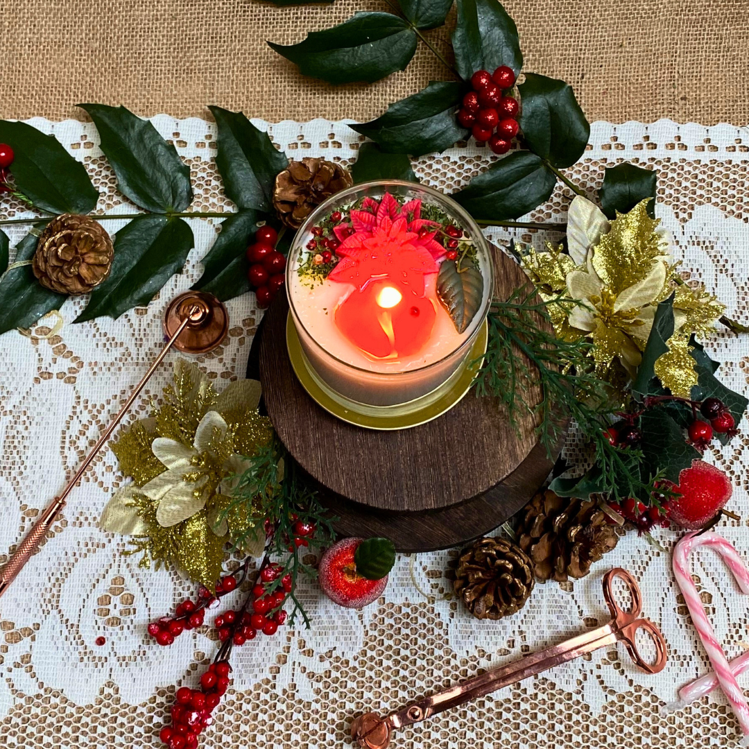 Large glass Winter Poinsettia candle lifestyle shot styled for Christmas home décor with Hollyberry fragrance