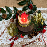 Large glass Winter Poinsettia candle lifestyle shot styled for Christmas home décor with Hollyberry fragrance