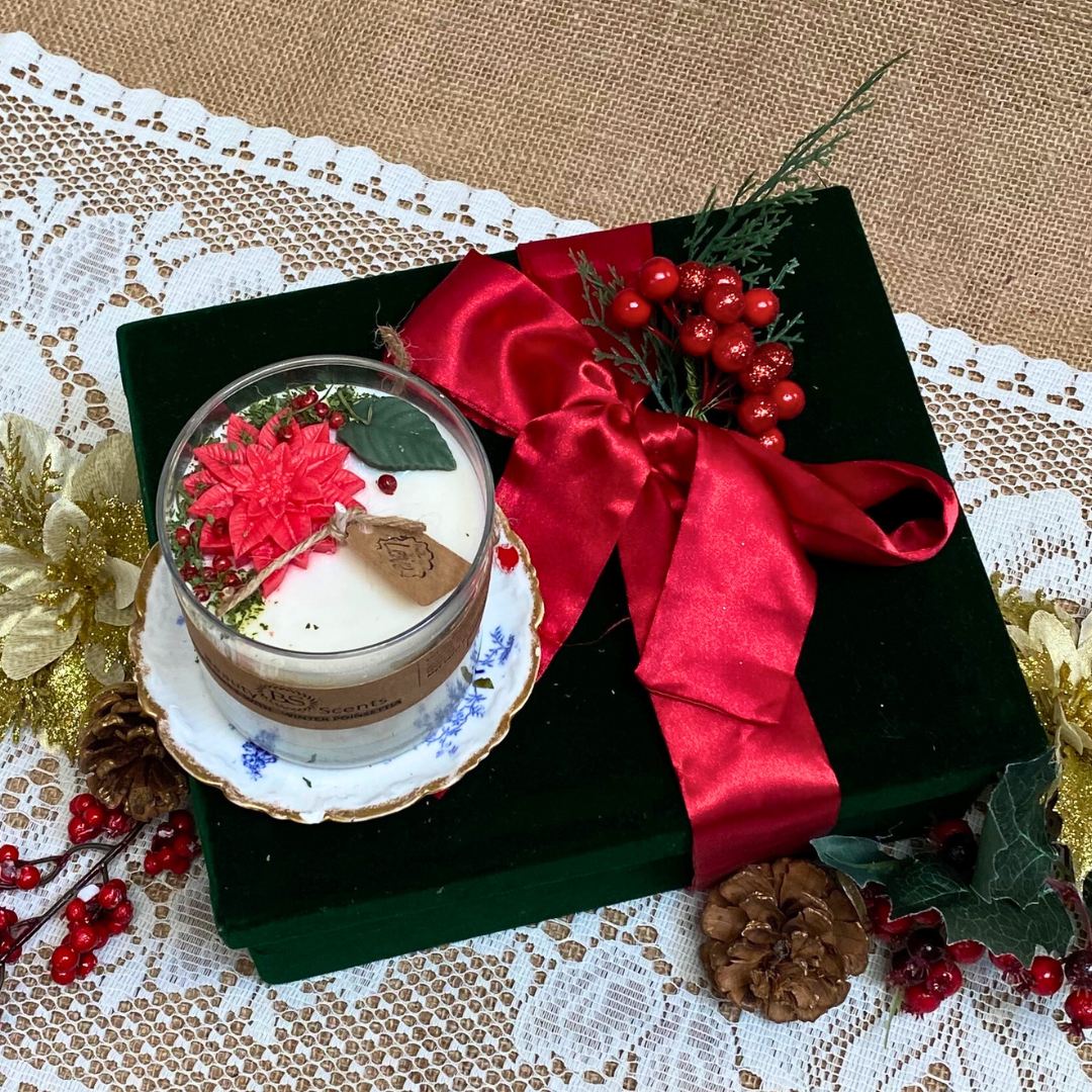 Large glass Winter Poinsettia candle side view showing white wax with festive botanical decoration