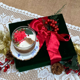 Large glass Winter Poinsettia candle side view showing white wax with festive botanical decoration