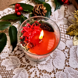 Large glass Winter Poinsettia candle main product image with red poinsettia flowers in glass container
