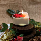 Large heart Winter Poinsettia candle top view with red poinsettia flower arrangement on white wax