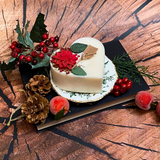 Large heart Winter Poinsettia candle close-up showing detailed corner decoration with red berries