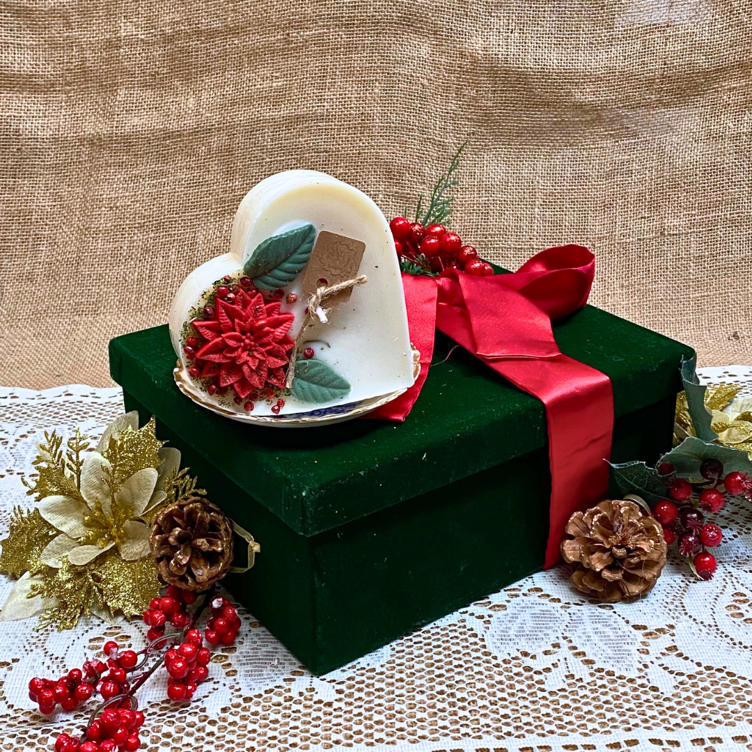 Large heart Winter Poinsettia candle side view showing white wax with festive botanical decoration