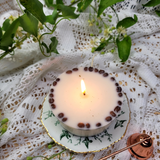 Medium low coffee bean candle burning with flame and coffee bean decoration