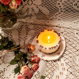Medium low coffee bean candle burning showing gentle flame and wax pool