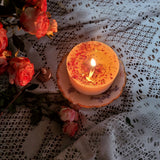 Medium rose petals scented candle 8.5cm height burning with warm golden light on antique plate - Beauty Scents handmade soy candle