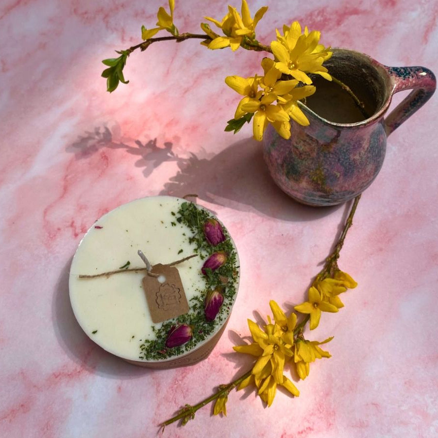 white candle with rose buds