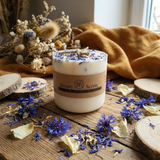 Handmade Beauty Scents candle with wildflowers, styled with yellow fabric, dried botanicals, and a cozy window background.