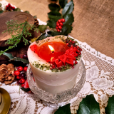 Medium Winter Poinsettia pillar candle main image with red poinsettia flowers and green leaves