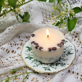Lit coffee candle on plate with warm flame and coffee aroma filling dining space