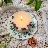 Coffee candle flame dancing on plate with coffee beans decoration and warm lighting