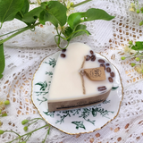 Small heart coffee bean candle burning showing gentle flame and romantic ambiance