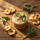 beauty scents small apple candle surrounded  with dried apples and leaves on a wooden surface