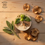Beauty Scents small apple candle top view with dried apple slices and green apples on a wooden surface with 'Beauty Scents' branding.