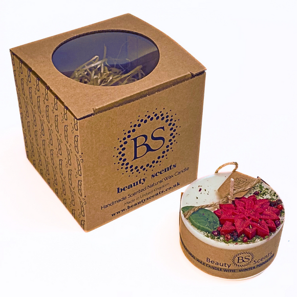 Small Winter Poinsettia pillar candle with Hollyberry scent featuring red poinsettia flowers and green leaves