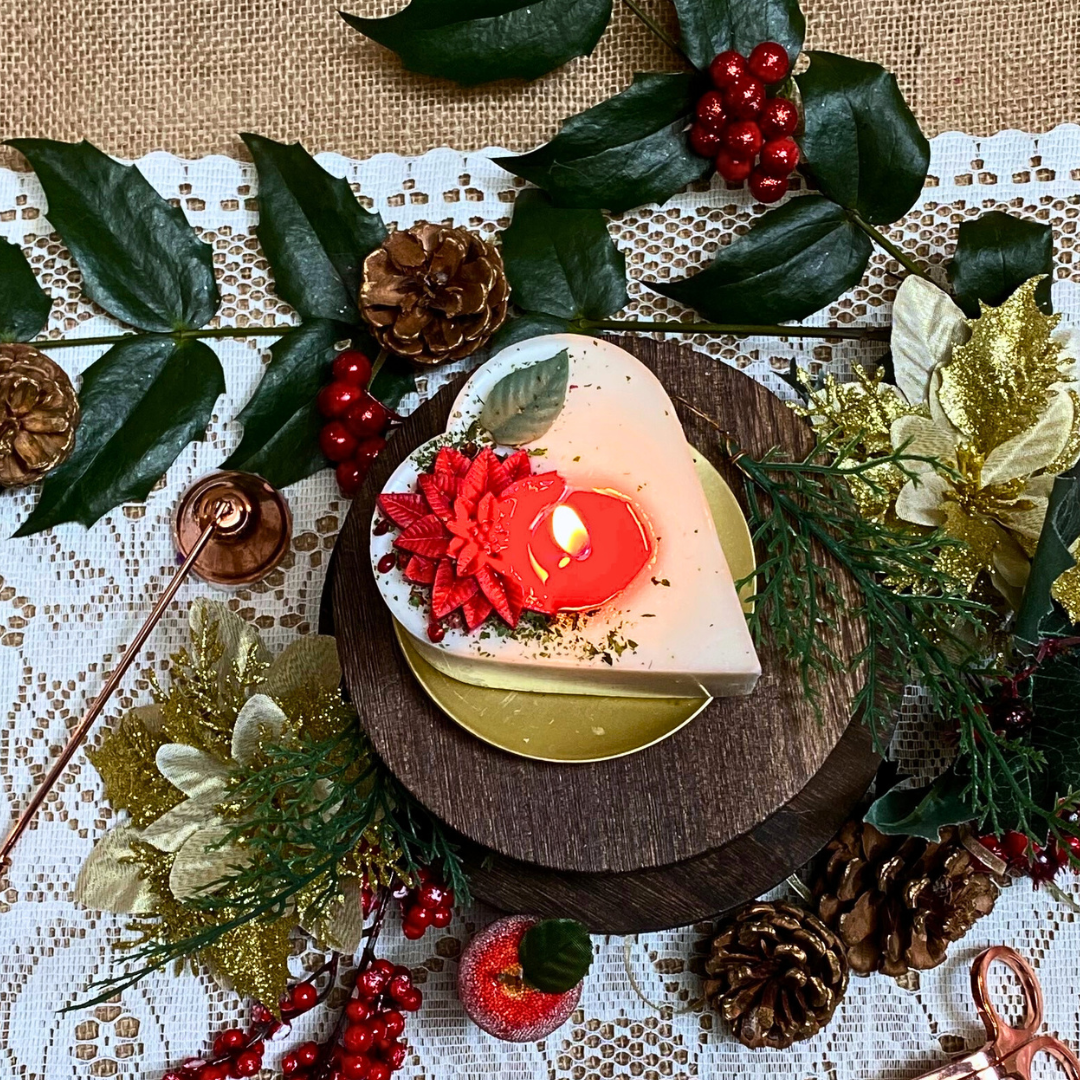 Small heart Winter Poinsettia candle lifestyle styling with Christmas décor and Hollyberry fragrance