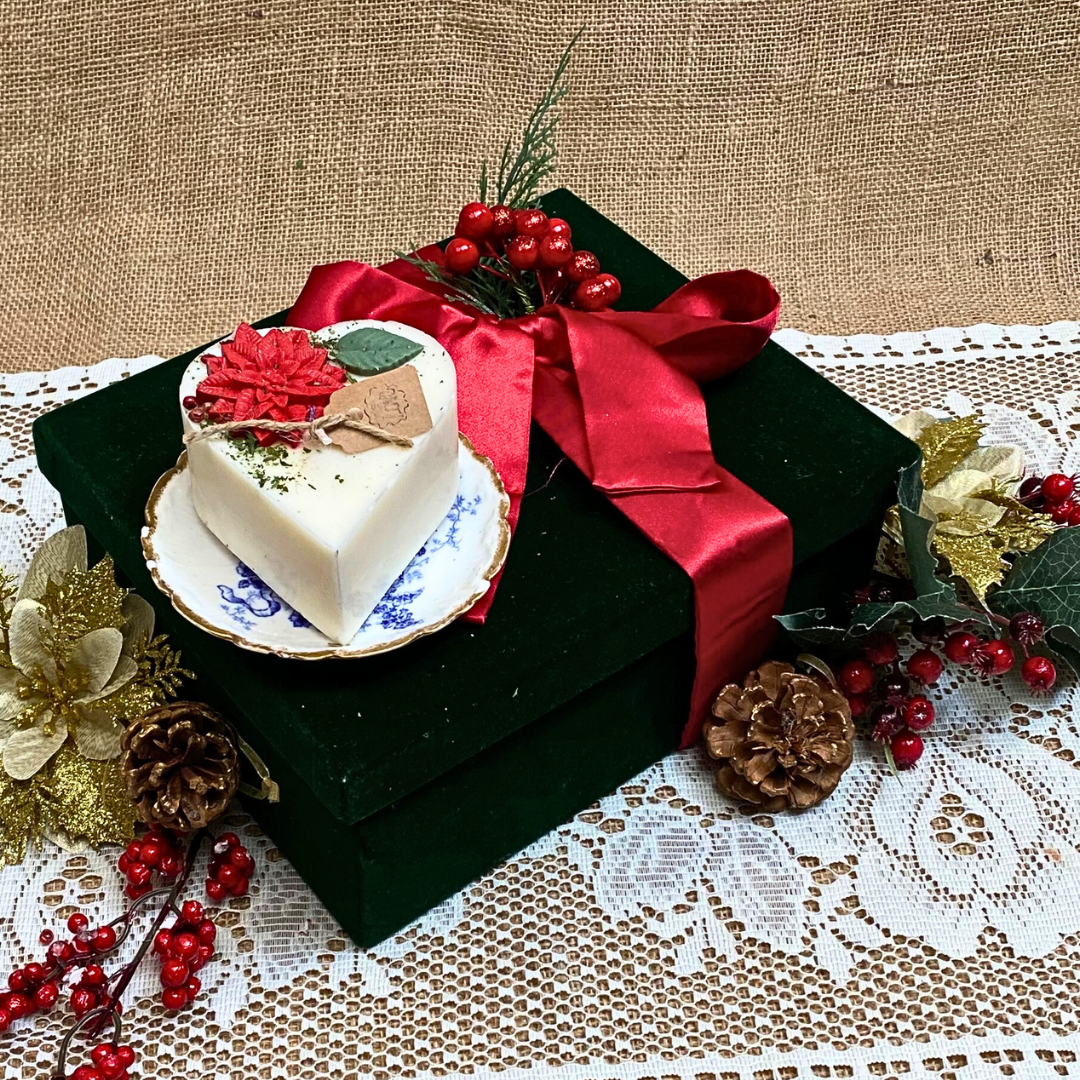 Small heart Winter Poinsettia candle angle view displaying handcrafted soy wax heart shape