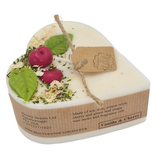 Heart-shaped candle with vanilla and cherry scented on the label, featuring Heart-shaped candle with wax cherries and green leafs on a white background.
