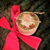 Small mulled wine scented candle decorated with star anise and red berries on white soy wax background