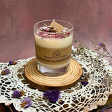 Beauty Scents small glass rose petals candle styled with natural wood base, dried flowers, and handmade lace trim