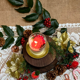 Small glass Winter Poinsettia candle lifestyle shot styled for Christmas home décor with Hollyberry fragrance