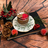 Small glass Winter Poinsettia candle angle view displaying handcrafted soy wax in glass container