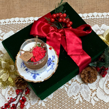 Small glass Winter Poinsettia candle side view showing white wax with festive botanical decoration