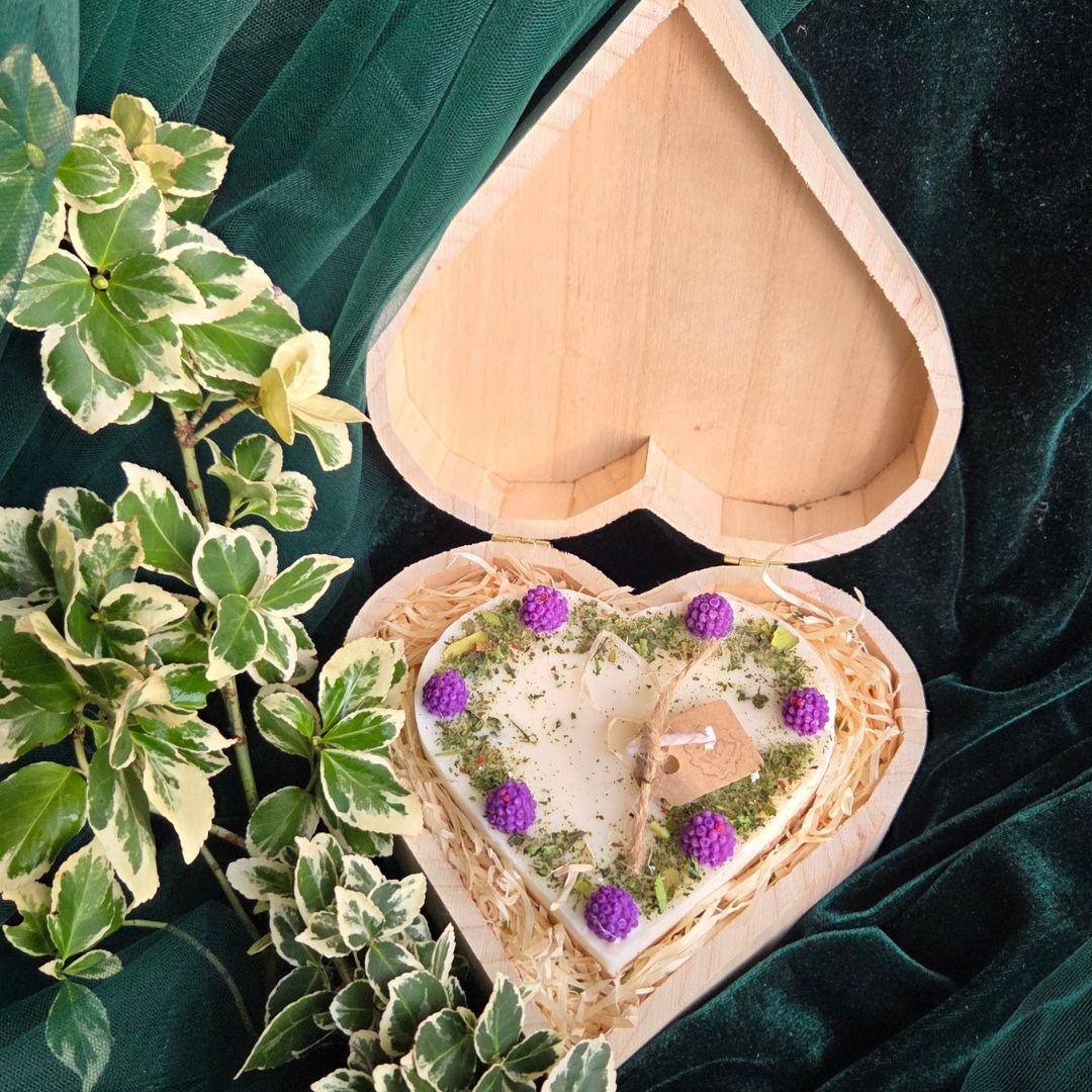 Handmade heart candle decorated with blackberries, set in rustic wooden box