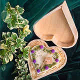 Top view of heart candle with blackberry details in a wooden gift box