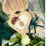 Handmade heart candle decorated with rose buds in rustic wooden box