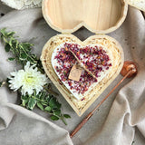 Close-up of rose petal heart candle in eco-friendly wooden box