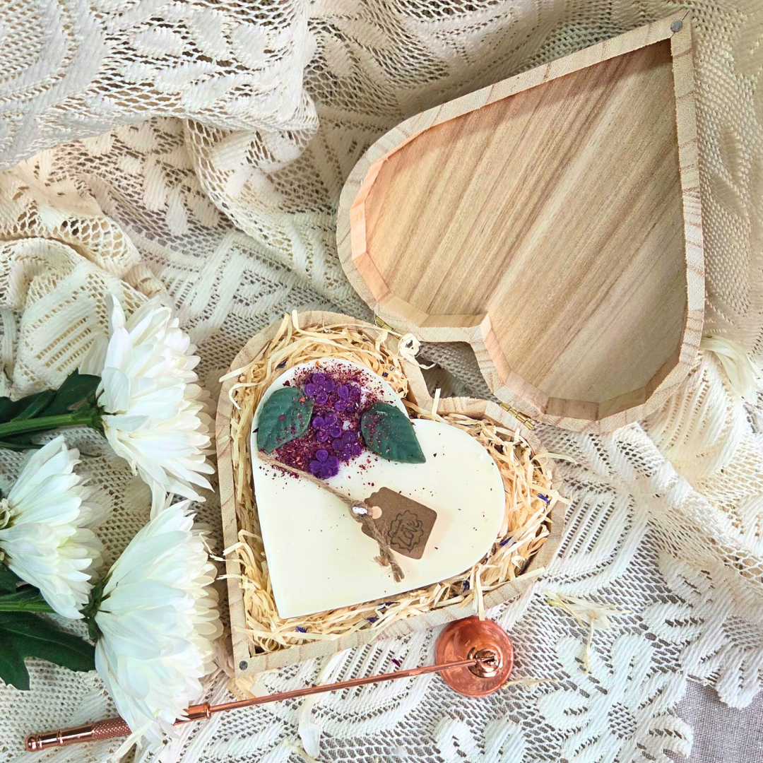Close-up of lilac heart candle in eco-friendly wooden box