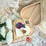 Close-up of lilac heart candle in eco-friendly wooden box