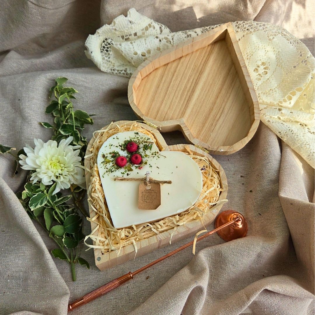 Close-up of red berry heart candle in eco-friendly wooden box