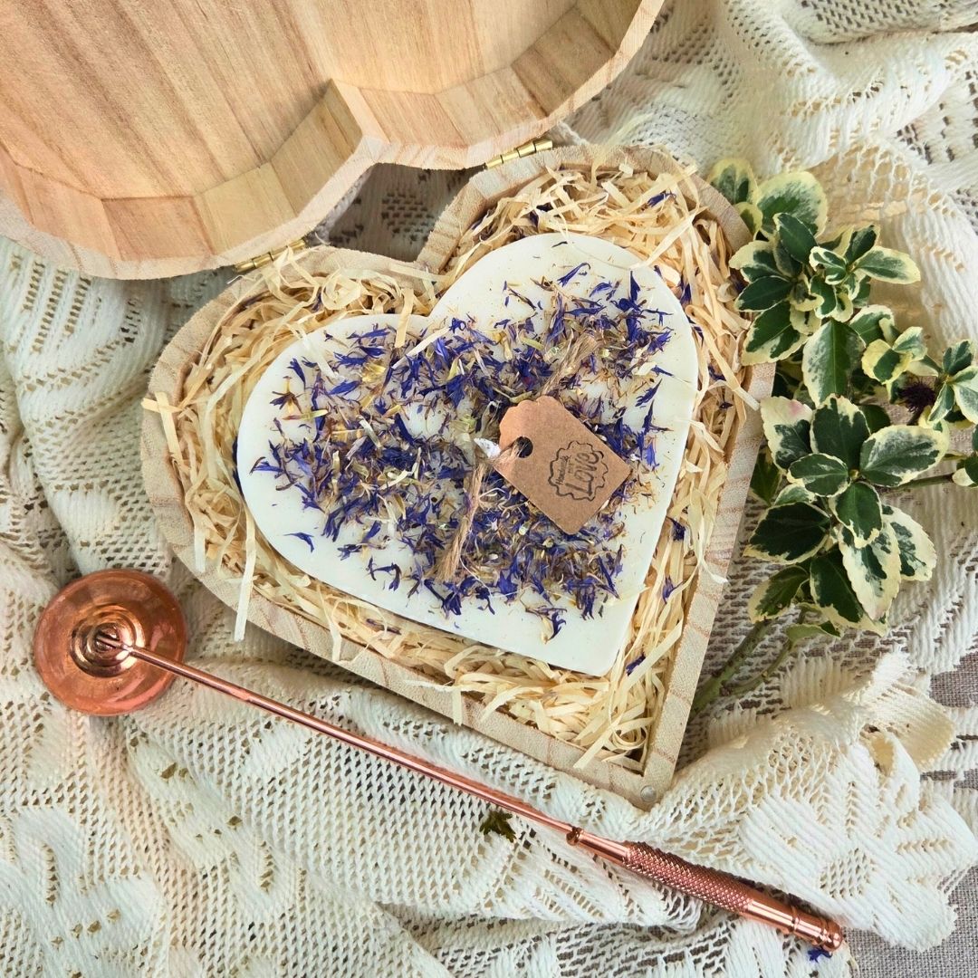 Close-up of wild flower heart candle in eco-friendly wooden box