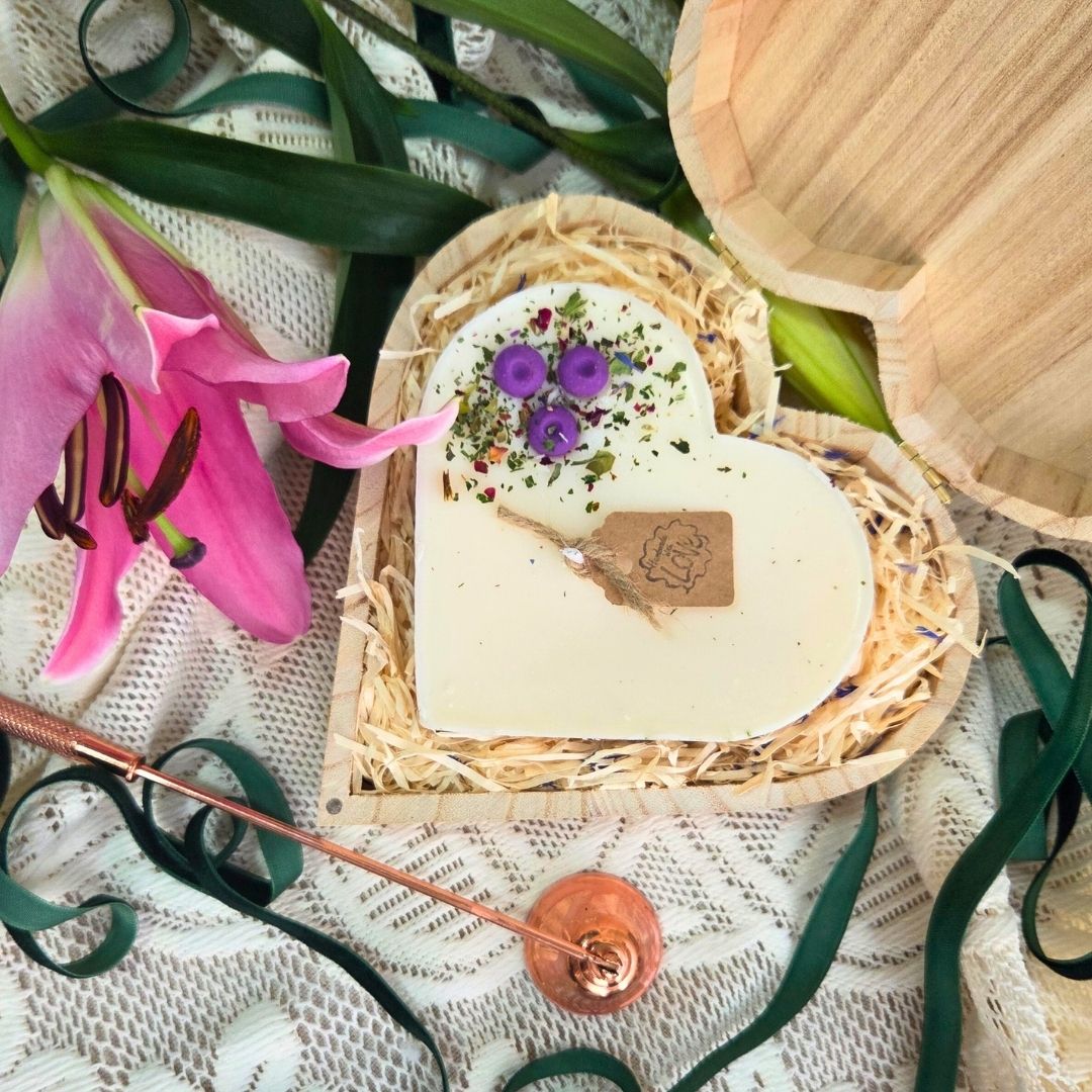 Handmade heart candle decorated with blueberries, set in rustic wooden box