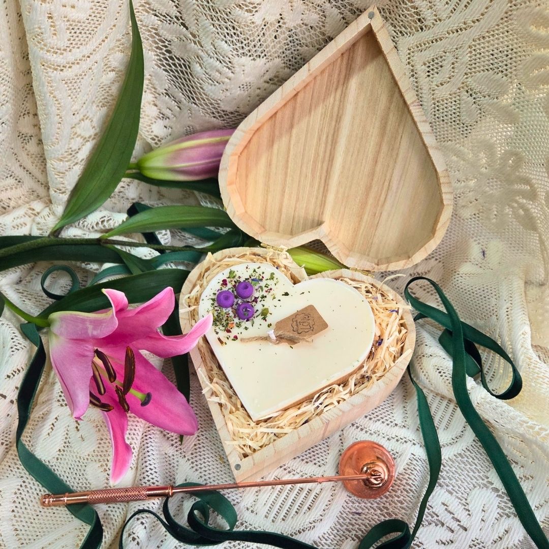 Top view of heart candle with blueberry details in a wooden gift box